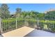 Exterior patio view featuring metal railings and a lush green garden view, showcasing outdoor living at 1842 Lake Ridge Dr, The Villages, FL 32162