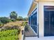 Exterior patio view featuring metal railings with a lush green garden view, showcasing outdoor living at 1842 Lake Ridge Dr, The Villages, FL 32162
