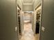 Hallway to bathroom with a large tub and a dual walk-in closet at 1893 Banning Beach Rd, Tavares, FL 32778
