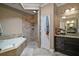 Luxurious bathroom with a deep soaking tub, walk-in shower, and double vanity, offering a spa-like experience at 1893 Banning Beach Rd, Tavares, FL 32778