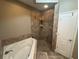 Tiled bathroom with large shower and soaking tub at 1893 Banning Beach Rd, Tavares, FL 32778