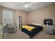 Cozy bedroom with a comfortable bed, accent chair, and window with plantation shutters, creating a relaxing atmosphere at 1893 Banning Beach Rd, Tavares, FL 32778