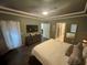 Spacious bedroom with coffered ceilings, modern furniture, and access to the ensuite bathroom at 1893 Banning Beach Rd, Tavares, FL 32778