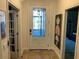 Welcoming foyer with a decorative glass front door and neutral decor at 1893 Banning Beach Rd, Tavares, FL 32778