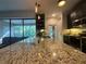 Spacious kitchen featuring granite countertops, a large island, and modern pendant lighting at 1893 Banning Beach Rd, Tavares, FL 32778