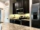 The kitchen features dark wood cabinetry, stainless steel appliances, and granite countertops at 1893 Banning Beach Rd, Tavares, FL 32778