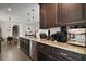 Spacious kitchen with dark wood cabinetry, stainless steel appliances, and granite countertops at 1893 Banning Beach Rd, Tavares, FL 32778