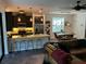 Open concept kitchen with granite countertops, breakfast bar, modern pendant lighting, and stainless appliances at 1893 Banning Beach Rd, Tavares, FL 32778