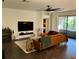 Cozy living room with modern furnishings, a large TV, and a comfortable leather sofa at 1893 Banning Beach Rd, Tavares, FL 32778