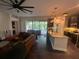 Open concept living room showing modern design and flows into the kitchen with access to outdoor patio at 1893 Banning Beach Rd, Tavares, FL 32778