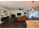 Open concept living room with hardwood floors, modern furnishings, and access to the patio at 1893 Banning Beach Rd, Tavares, FL 32778