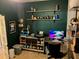 Home office featuring a desk area with a monitor, printer, and shelves with various items at 1893 Banning Beach Rd, Tavares, FL 32778