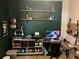 Home office space with dark green walls, multiple shelves and 3d printing station at 1893 Banning Beach Rd, Tavares, FL 32778