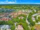 An aerial view shows the property in a maturely landscaped community with easy access to roads and highways at 2102 Estevez Dr, Lady Lake, FL 32159