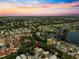 An aerial view of a residential community and small lake at sunset at 2102 Estevez Dr, Lady Lake, FL 32159