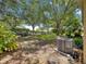 A spacious backyard with a lush lawn and mature trees provides a private outdoor space at 2102 Estevez Dr, Lady Lake, FL 32159