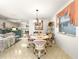 Open concept dining area with stylish decor and abundant natural light, seamlessly connecting to the living room and kitchen at 2102 Estevez Dr, Lady Lake, FL 32159