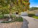Charming single-story home with a white picket fence and a well-manicured front yard and two-car garage at 2102 Estevez Dr, Lady Lake, FL 32159