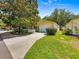 Cozy one-story home with a well-kept lawn, lovely landscaping and a large driveway leading to an attached two-car garage at 2102 Estevez Dr, Lady Lake, FL 32159