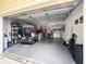 Attached garage with vehicle, storage shelves and laundry area at 2102 Estevez Dr, Lady Lake, FL 32159