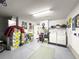 Large garage space with laundry machines and storage areas at 2102 Estevez Dr, Lady Lake, FL 32159