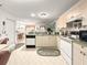 Well-lit kitchen with a seamless flow to the dining area, showcasing white appliances and ample counter space at 2102 Estevez Dr, Lady Lake, FL 32159
