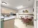 Functional kitchen with essential appliances and a quaint dining space illuminated by a unique chandelier at 2102 Estevez Dr, Lady Lake, FL 32159