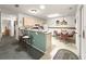 Charming kitchen featuring a breakfast bar, ample cabinet space, and a cozy dining area at 2102 Estevez Dr, Lady Lake, FL 32159