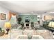 Inviting living room with a decorative fireplace, plush seating, and abundant natural light at 2102 Estevez Dr, Lady Lake, FL 32159