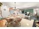 Open concept with dining and living area bathed in natural light, seamlessly connected for modern living at 2102 Estevez Dr, Lady Lake, FL 32159