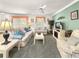 Cozy living room featuring comfortable seating, a decorative fireplace, and bright natural light at 2102 Estevez Dr, Lady Lake, FL 32159