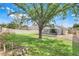 Sprawling backyard with mature tree, lawn, and screened-in pool area at 2136 Fish Eagle St, Clermont, FL 34714