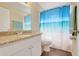 Bathroom with granite countertop, white cabinets, and shower with a beach-themed curtain at 2136 Fish Eagle St, Clermont, FL 34714