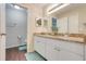 Bathroom featuring double sinks, granite countertop, and wood-look flooring at 2136 Fish Eagle St, Clermont, FL 34714