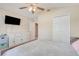 Bright bedroom boasts a ceiling fan, natural light, and ample space, enhancing the room's appeal and functionality at 2136 Fish Eagle St, Clermont, FL 34714