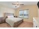 Comfortable bedroom featuring a wooden bed frame, neutral walls, carpet and a large window at 2136 Fish Eagle St, Clermont, FL 34714