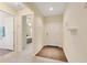 Inviting foyer features wood-look flooring and a view into a bright, carpeted bedroom enhancing the home's appeal at 2136 Fish Eagle St, Clermont, FL 34714