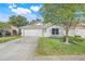 Charming single-story home featuring a well-manicured lawn and two car garage at 2136 Fish Eagle St, Clermont, FL 34714
