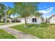 Charming single-story home featuring a well-manicured lawn and two car garage at 2136 Fish Eagle St, Clermont, FL 34714