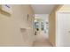 Welcoming hallway with neutral walls and plush carpeting leading to the living area, creating a seamless transition at 2136 Fish Eagle St, Clermont, FL 34714