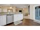 Kitchen with stainless steel dishwasher, sink, and wood grain vinyl floors at 2136 Fish Eagle St, Clermont, FL 34714