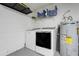 Utility room with washer, dryer, water heater, and storage shelves at 2136 Fish Eagle St, Clermont, FL 34714