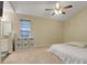 Bright main bedroom featuring neutral walls, carpet, and a ceiling fan, creating a cozy and inviting retreat at 2136 Fish Eagle St, Clermont, FL 34714