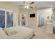 Spacious main bedroom with sliding glass doors to patio, en-suite bathroom, and a ceiling fan at 2136 Fish Eagle St, Clermont, FL 34714