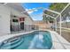 Sparkling pool with screen enclosure and safety fence in the backyard at 2136 Fish Eagle St, Clermont, FL 34714