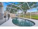 Backyard pool enclosed with a screen and fence at 2136 Fish Eagle St, Clermont, FL 34714