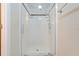 Modern shower with glass door, white tile, and dual shower heads for a spa-like experience at 2136 Fish Eagle St, Clermont, FL 34714