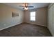 Comfortable carpeted bedroom with a bright window and a charming painting on the wall, creating a cozy atmosphere at 222 Locust Ln, Ocala, FL 34471