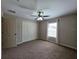 Bedroom with carpet, ceiling fan, closet, and a bright window, provides ample space and natural light at 222 Locust Ln, Ocala, FL 34471