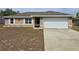 Charming single-story home with a two-car garage and well-maintained landscaping at 222 Locust Ln, Ocala, FL 34471